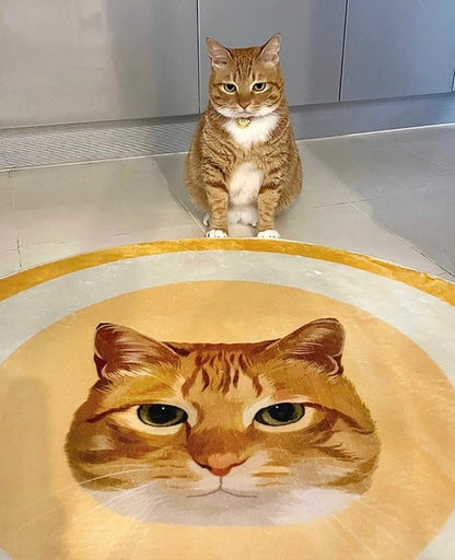 Cat sitting on a floor with a rug featuring its face.